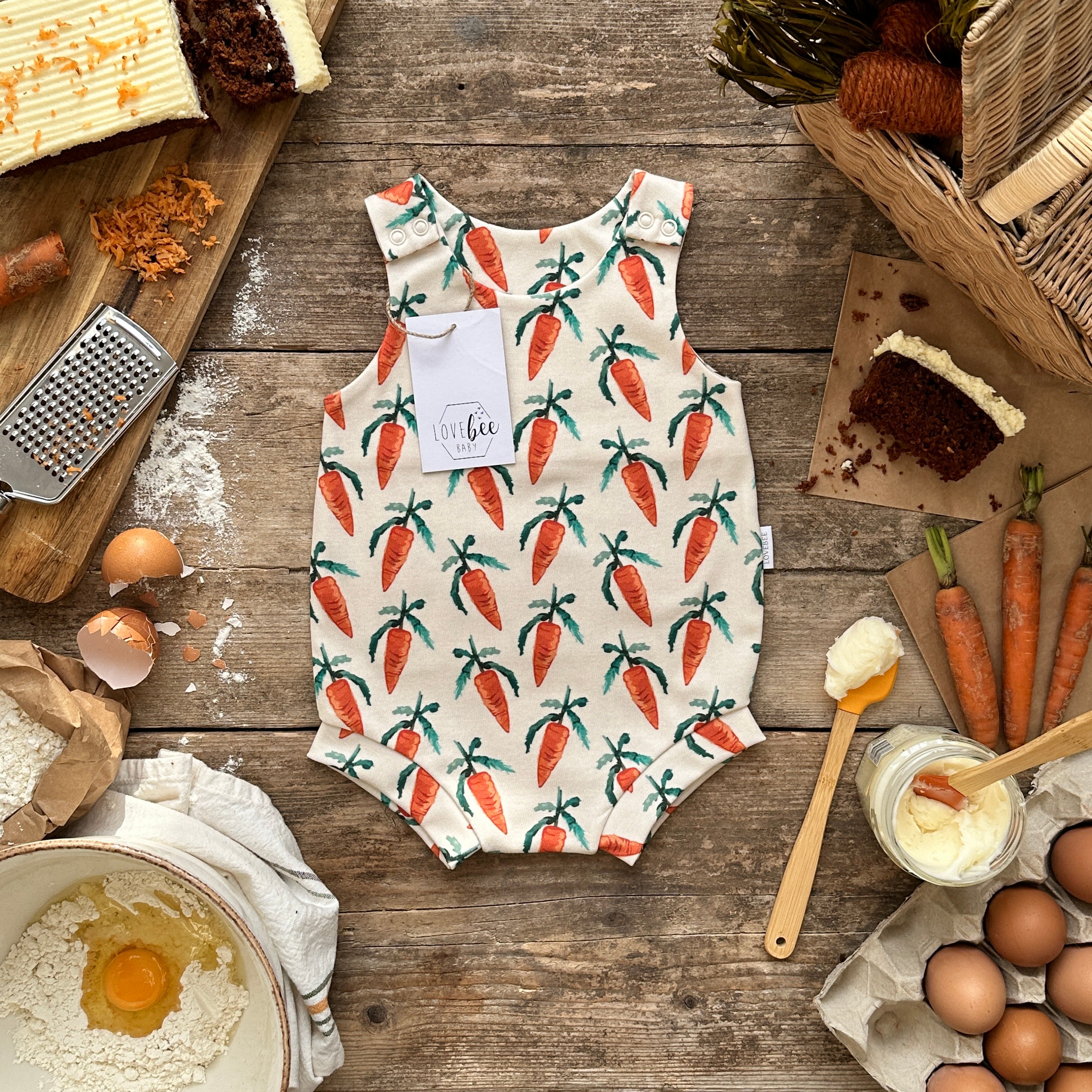 http://www.lovebeebaby.com/cdn/shop/products/lovebee-club-carrot-printed-bloomer-romper.jpg?v=1676659089